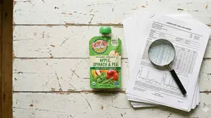 Happy Baby Organics purity award comparison with heavy metal lab test results on a table