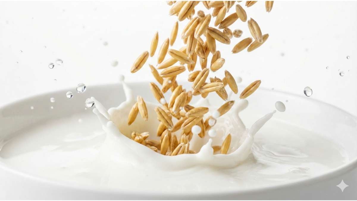 Raw organic oats splashing into pure milk, symbolizing glyphosate-free ingredients.